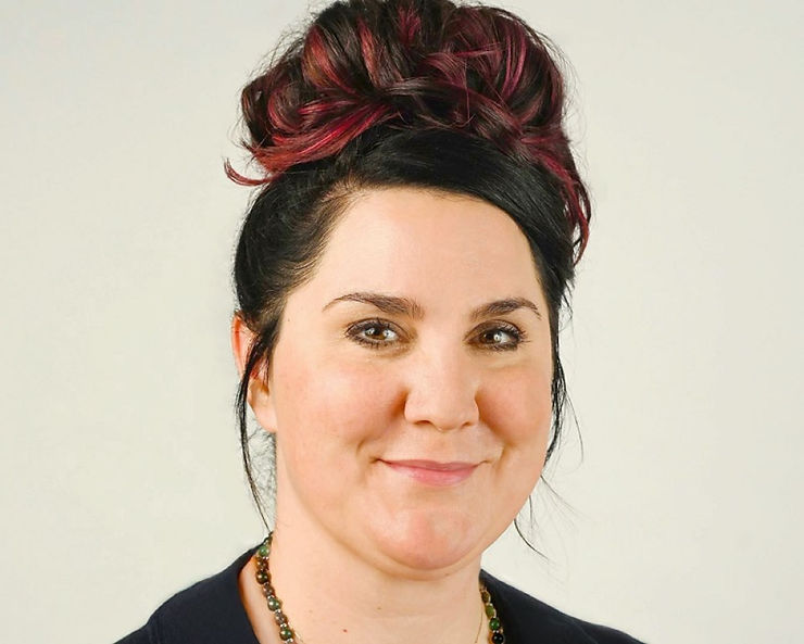 Portrait of a woman with dark hair tied in a bun